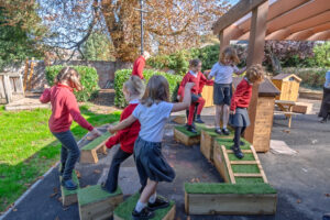 Children playing on a wooden obstacle course 