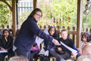 Hayley Cowell handing things out to children 