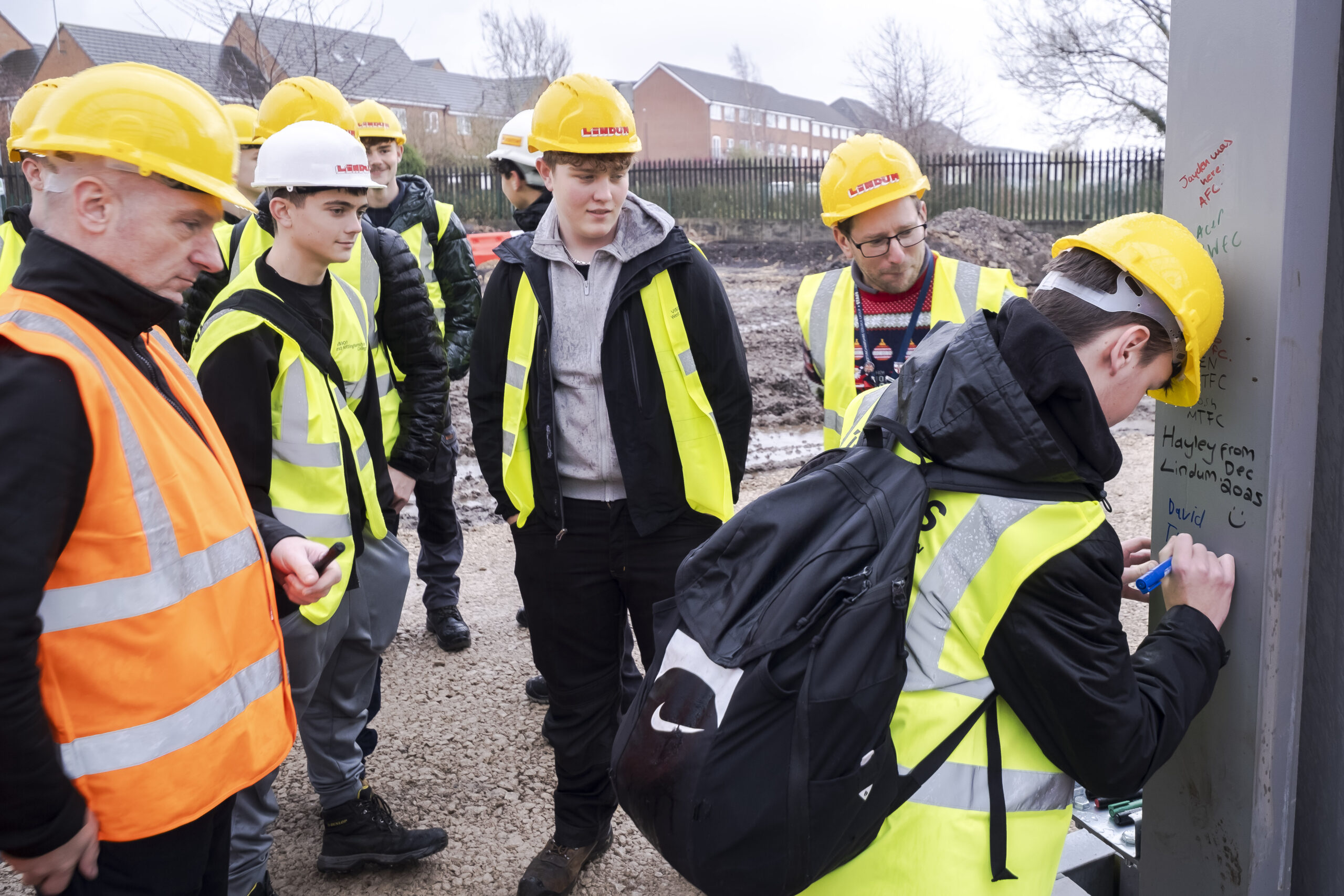 Students sign steel structure of new Lindum-built depot and learning campus